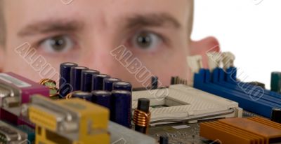 Man examines an electronic circuit