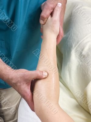 Woman having arm massage from masseur