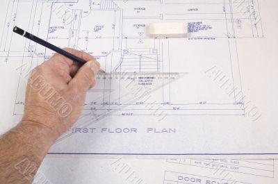 Architect, drawing up plans for a house