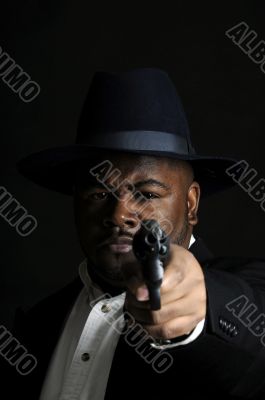young African American man with gun pointed