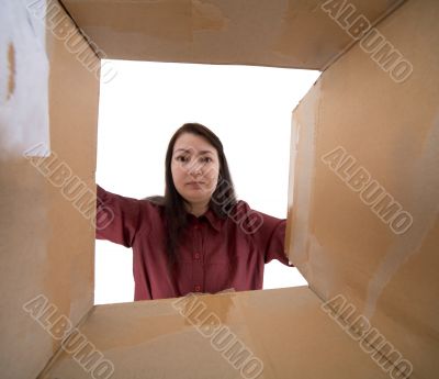 Female face into cardboard box