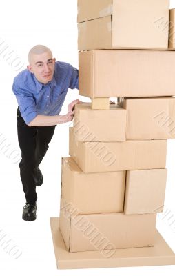 Man pushing heap from cardboard boxes