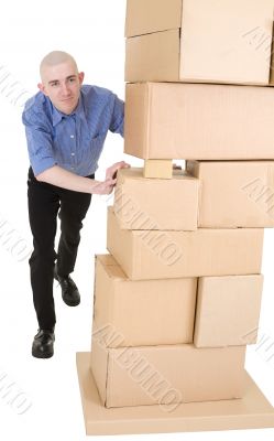 Man pushing heap from cardboard boxes