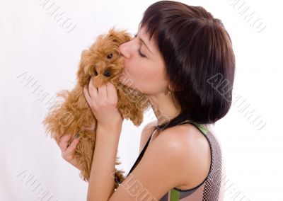 The girl kisses a puppy