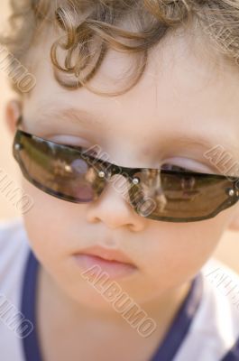 Boy in sun glasses close up