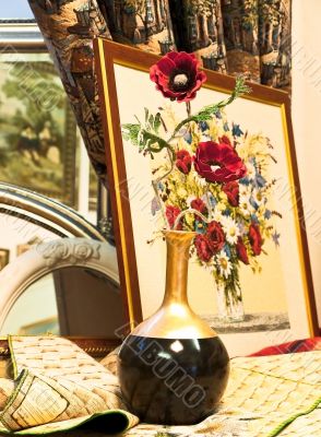 gobelin picture with red flowers near it gobelin picture with red flowers near it