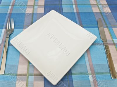 dish with fork and knife at tablecloth