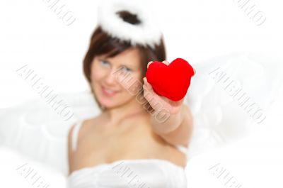 Young woman in angel`s costume with red heart