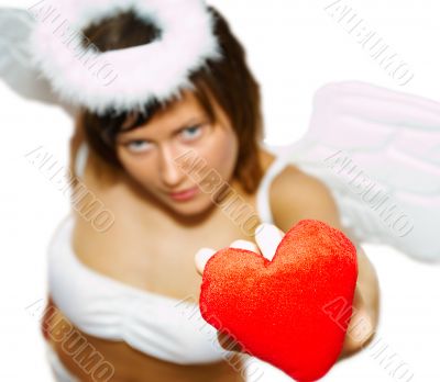 Young woman at angel`s costume with red heart