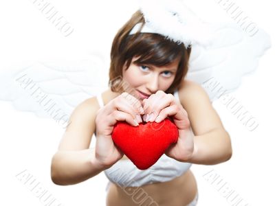 Young woman in angel`s costume with red heart