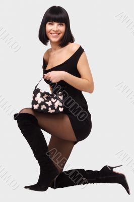Smiling young woman in little black dress