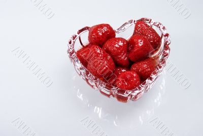 Strawberry in a syrup in glass heart
