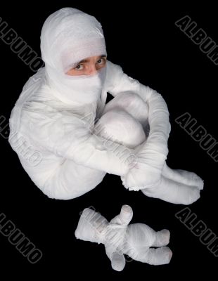 Egyptian mummy emo sitting on a black