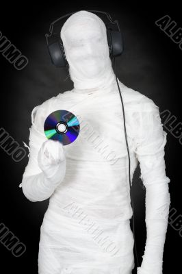 Man in bandage with ear-phones and disc