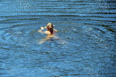 single female figure in wide water surface