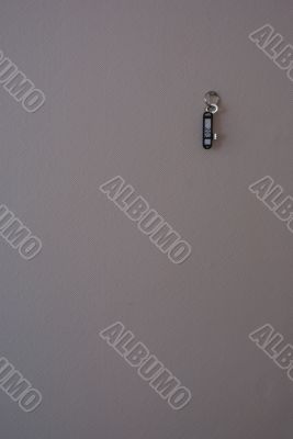 Key hang by a nail on the grey wall