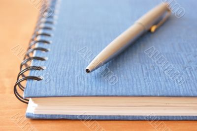 Writing materials on the light brown wooden table