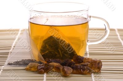 white tea, nylon tea-bag and golden sugar