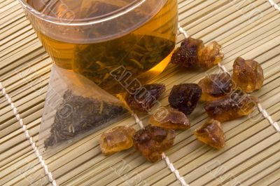 white tea, nylon tea-bag and golden sugar