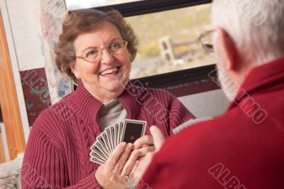 Happy Senior Adult Couple Playing Cards