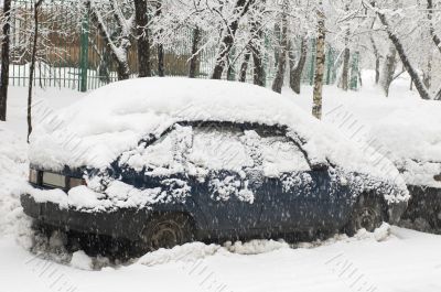 Blue car in snowfall