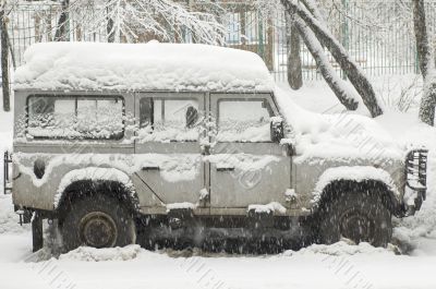Grey car in snowfall