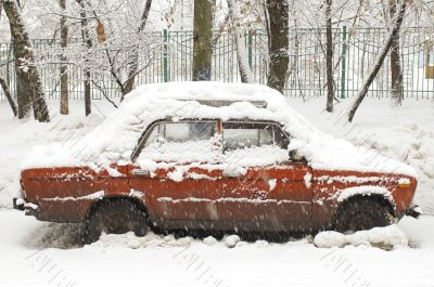 Red car in snowfall