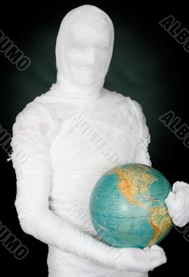 Man in costume mummy and terrestrial globe