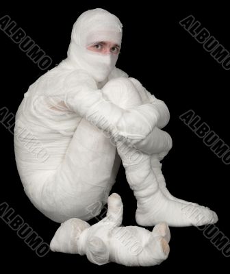 Egyptian mummy emo sitting on a black