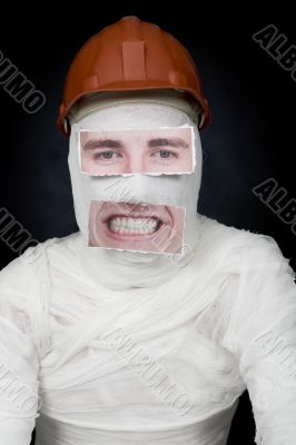 Guy in bandage with the helmet and false face