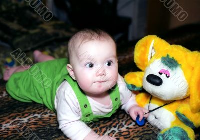 Infant with yellow chinchilla toy