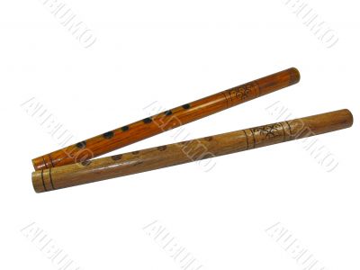 Two vintage wooden musical pipes isolated over white background