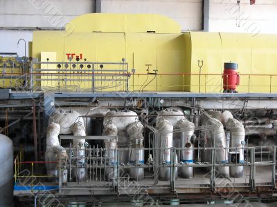 Steam turbine at a power plant with tubes and machinery Steam turbine at a power plant with tubes and machinery