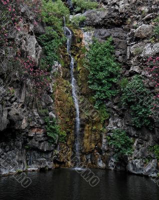 Waterfall on black basalt rocks