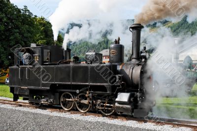 Historical steam engine on tracks
