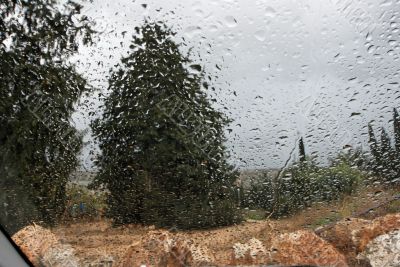 Rainy landscape in car window