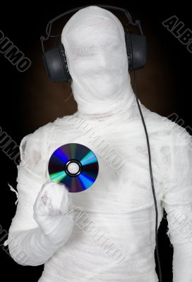 Man in bandage with ear-phones and disc