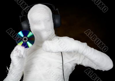 DJ costume mummy with ear-phones and disc