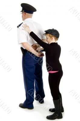 little girl is handcuffing a police officer