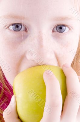 close up of a girl biting an apple