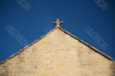 stone cross over triangle covering