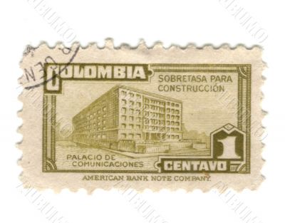Old green stamp from Colombia with building