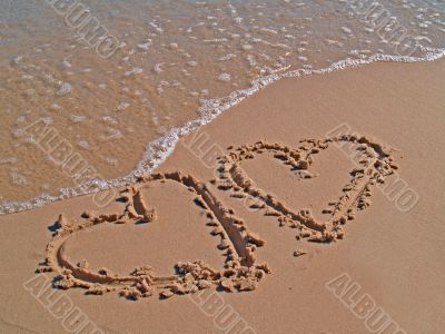 Hearts drawn on sand