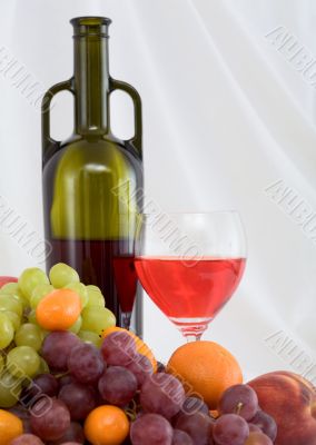Bright still life with wine and fruit