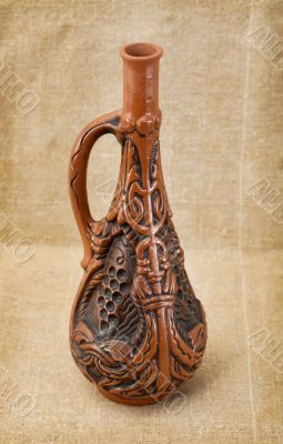Ceramic bottle on textile background