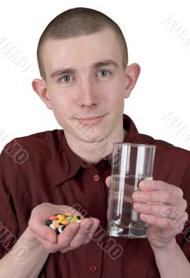 Boy with tablets and glass of water