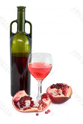 Glass of wine, bottle and a red pomegranate