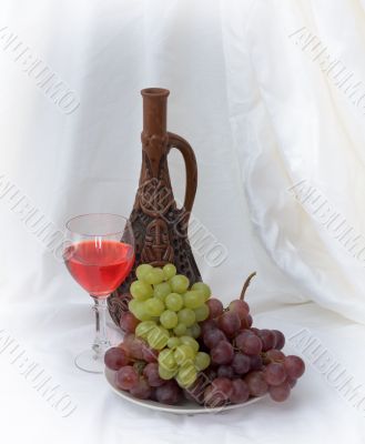 Bright still life with wine on white