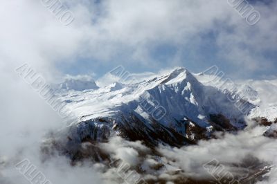 Peak surrounded by clouds. Swiss Alps