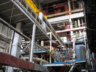 Machinery, tubes and steam turbines inside power plant Machinery, tubes and steam turbines inside power plant